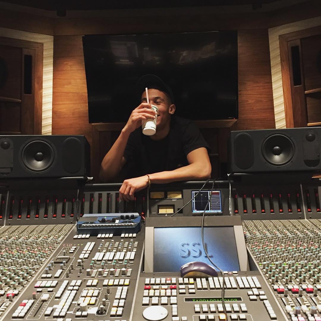 Truice Young in the production booth having a drink.